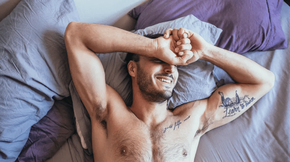 Image of a man in bed illustrating article about sex toys for men
