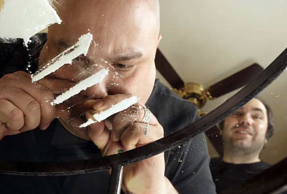 Man snorting cocaine illustrating sex and drugs